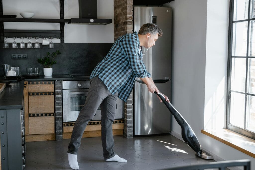 An automatic mop cleaning a tiled kitchen floor.