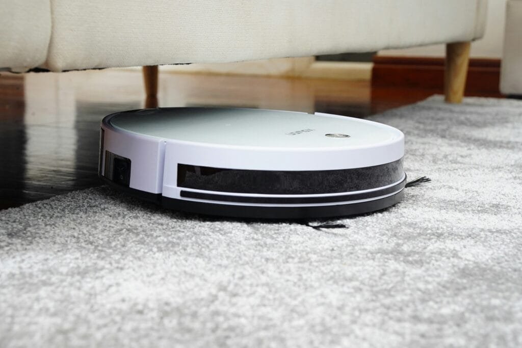 A robot vacuum cleaner navigating a living room with furniture
